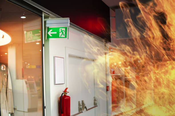 Emergency fire exit sign and fire in shopping mall.