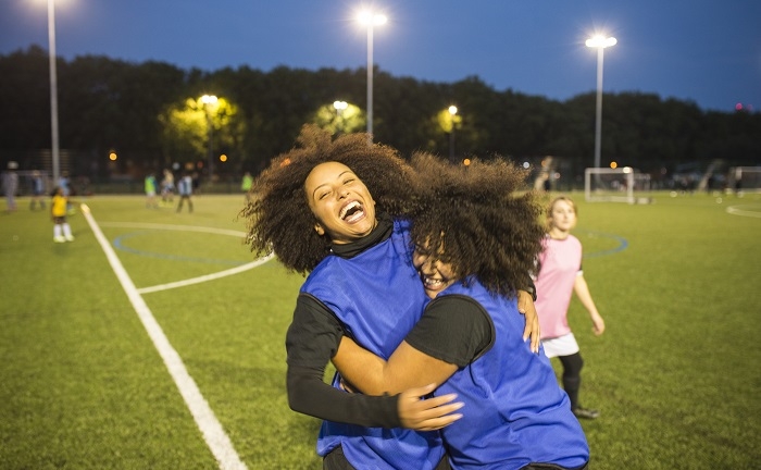 Female football players jubilant, Hackney, East London, UK
